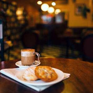 Cookies and a coffee on a table.
